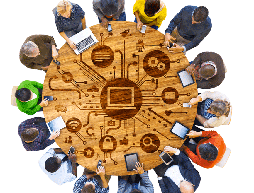 people around a table using their devices